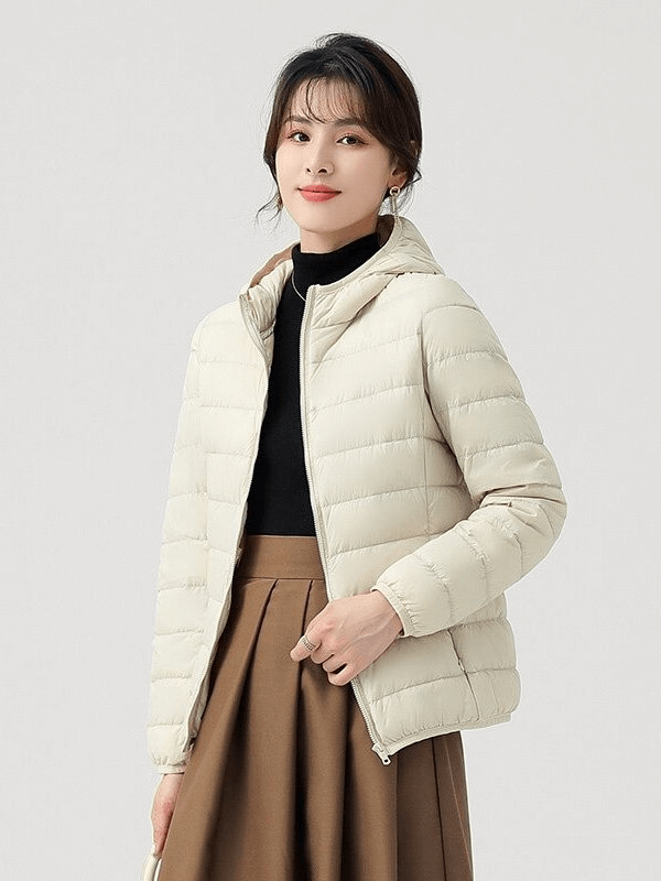Stylish women's down jacket with hood, lightweight, breathable, windproof, waterproof, in beige color.